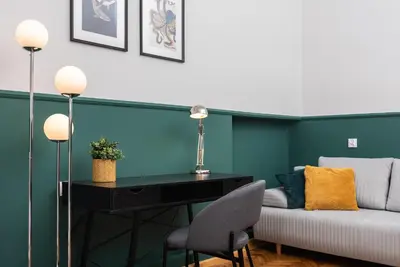a living room with a couch and a desk at Classy Old Town Apartment - by Upstairs in Kraków