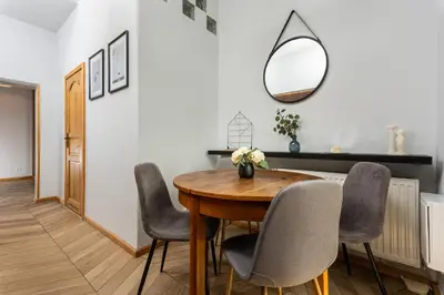 a dining room with a table and chairs and a mirror at Classy Old Town Apartment - by Upstairs in Kraków