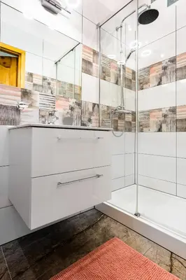 a bathroom with white cabinets and a glass shower at Classy Old Town Apartment - by Upstairs in Kraków