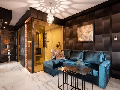 a living room with a blue couch and a table at Art Suites Boutique Hotel - Krakow Center in Kraków