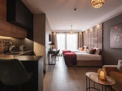 a hotel room with a bed and a kitchen at Art Suites Boutique Hotel - Krakow Center in Kraków