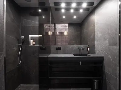 a black bathroom with a sink and a mirror at Art Suites Boutique Hotel - Krakow Center in Kraków