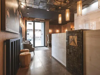a room with a lobby with a couch and a table at Art Suites Boutique Hotel - Krakow Center in Kraków