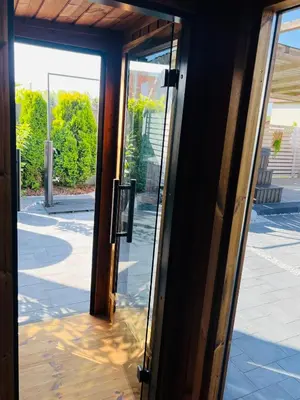 an open glass door with a view of a street at Old Tree Villa & Restaurant in Oświęcim