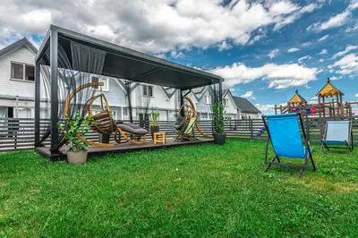 a gazebo with a playground in a yard at Old Tree Villa & Restaurant in Oświęcim