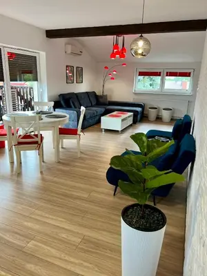 a living room with a blue couch and a table at Old Tree Villa & Restaurant in Oświęcim