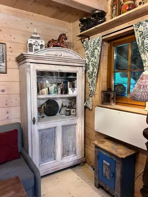 a wooden cabin with a cabinet in a room at Domek pod Jaworami z balią in Sułkowice