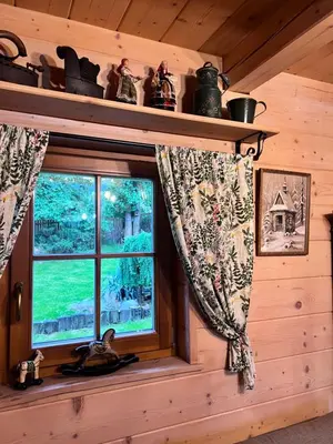 a window in a log cabin with a view at Domek pod Jaworami z balią in Sułkowice