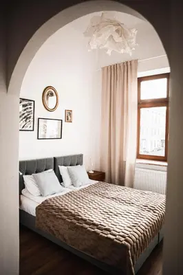 a bedroom with a bed and a window at Vilao Apartments in Kraków