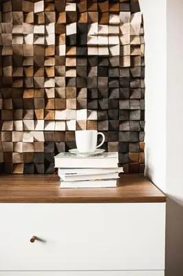 a stack of books and a cup of coffee on a shelf at Vilao Apartments in Kraków