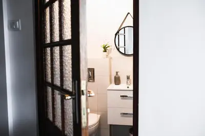 a bathroom with a toilet and a sink at Vilao Apartments in Kraków