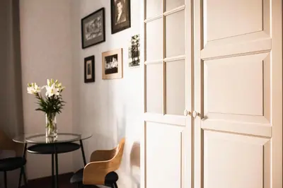 a door leading into a dining room with a table at Vilao Apartments in Kraków