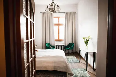 a bedroom with a bed and a table and chairs at Vilao Apartments in Kraków
