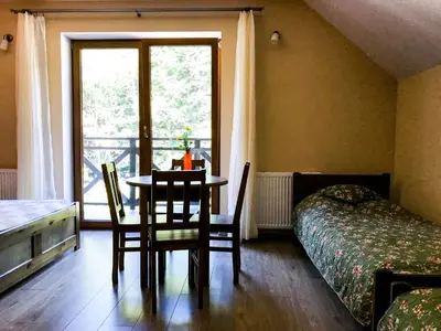 a room with a table and chairs and a window at OSADA WASYLÓWKA in Laskowa