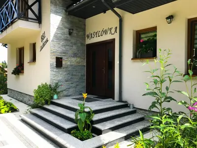 a front door of a building with a plant at OSADA WASYLÓWKA in Laskowa