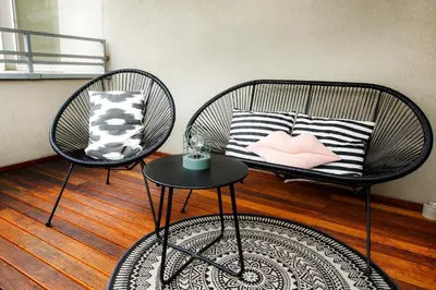 two chairs with pillows and a table in a room at Bochenka Apartments in Kraków