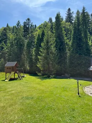 a large field with a playground in the grass at Domek na Cepcowym in Obidowa