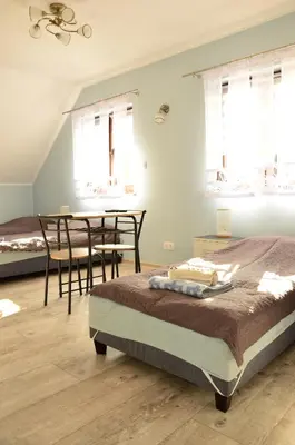a bedroom with a bed and a table and chairs at Pokoje gościnne u Grażki in Jerzmanowice