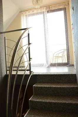 a staircase with a wrought iron railing and a window at Pokoje gościnne u Grażki in Jerzmanowice