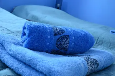 a blue towel sitting on top of a bed at Pokoje gościnne u Grażki in Jerzmanowice