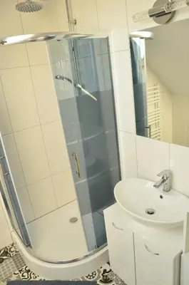 a bathroom with a shower and a sink at Pokoje gościnne u Grażki in Jerzmanowice