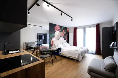 a living room with a bed and a dining room at Aparthotel Inspire Miodova Residence in Kraków