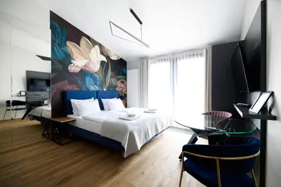 a bedroom with a bed and a painting on the wall at Aparthotel Inspire Miodova Residence in Kraków