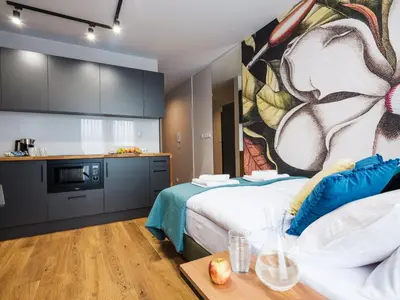 a hotel room with two beds and a kitchen at Aparthotel Inspire Miodova Residence in Kraków