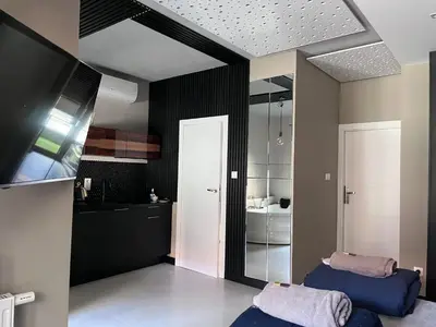 a bathroom with two beds and a mirror at Rakowicka Top Apartaments Superior in Kraków
