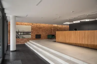 a lobby of a building with a brick wall at Rakowicka Top Apartaments Superior in Kraków