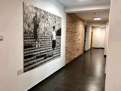 a hallway with a large painting on the wall at Rakowicka Top Apartaments Superior in Kraków