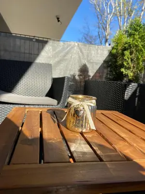 a glass vase sitting on top of a wooden table at Rakowicka Top Apartaments Superior in Kraków