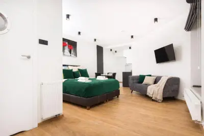 a living room with a bed and a couch at InPoint Krupnicza Apartment - 5 minut from Main Square Self Check-in in Kraków