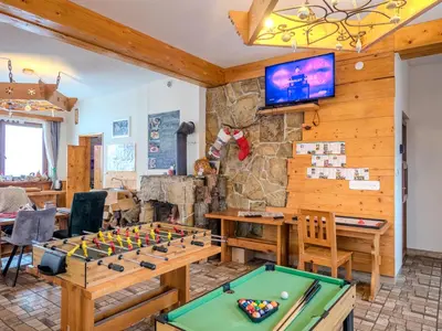 a living room with a pool table and a tv at Gazdówka na Mosornym Groniu in Zawoja