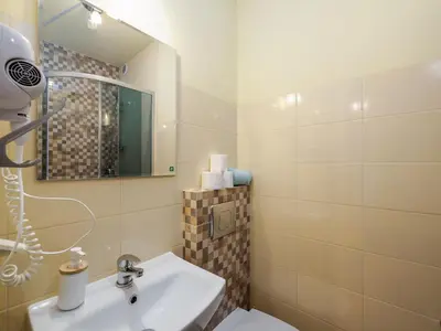 a bathroom with a sink and a mirror and a toilet at Gazdówka na Mosornym Groniu in Zawoja