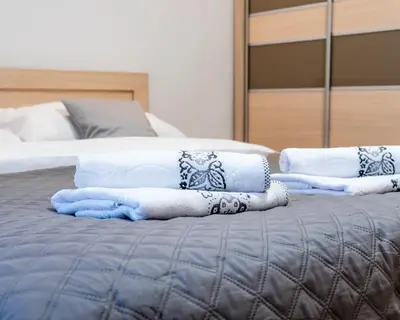 a bed with blue and white towels on it at Apartament Relax in Skawina