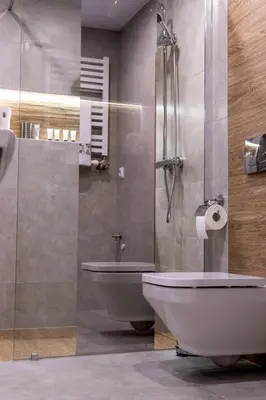 a bathroom with a toilet and a glass shower at Apartament Relax in Skawina