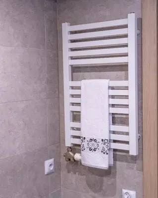 a towel rack in a shower in a bathroom at Apartament Relax in Skawina