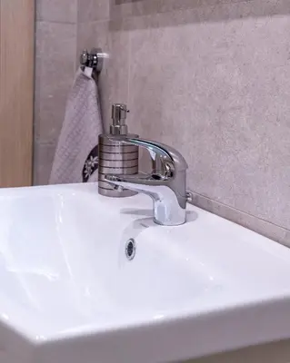 a bathroom sink with a silver faucet on it at Apartament Relax in Skawina
