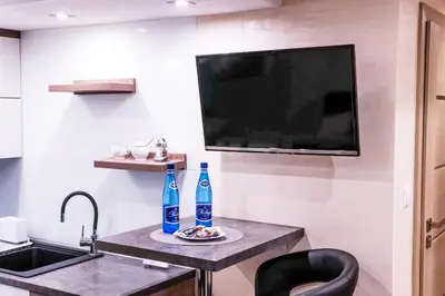 a small kitchen with a sink and two bottles of water at Apartament Relax in Skawina