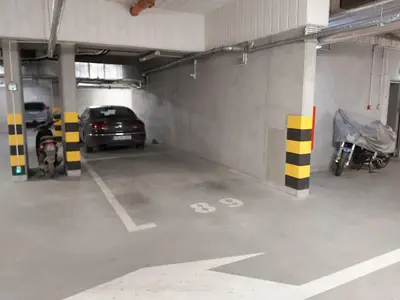 a parking garage with a car parked in it at Schindler’s Factory Zabłocie Deluxe Apartments WAWELOFTS in Kraków