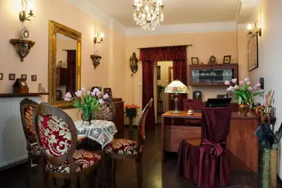 a living room with a table and chairs and a desk at Red Carpet Premium in Kraków