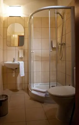 a bathroom with a shower and a toilet and a sink at Red Carpet Premium in Kraków