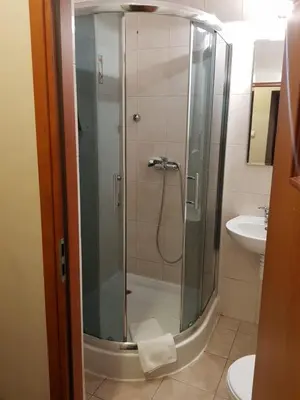 a shower with a glass door in a bathroom at Red Carpet Premium in Kraków