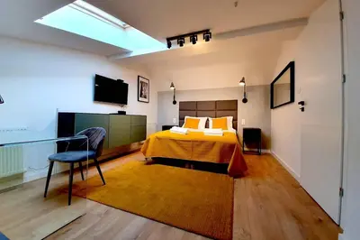 a bedroom with a bed and a television in it at Duplex apartment Morsztynowska in Kraków