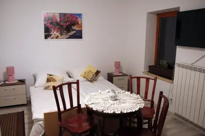 a bedroom with a bed and a table and chairs at Apartament U Jacka 2 in Rabka