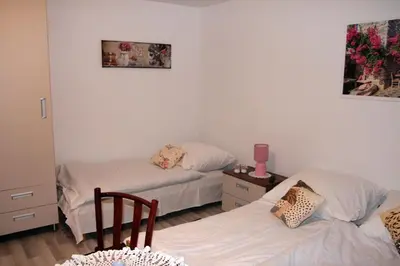 a room with a table with chairs and a bed at Apartament U Jacka 2 in Rabka
