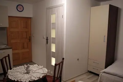 a bedroom with two beds and a table at Apartament U Jacka 2 in Rabka