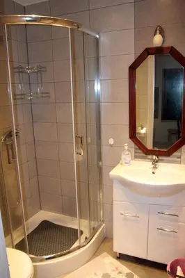 a bathroom with a white sink and a mirror at Apartament U Jacka 2 in Rabka