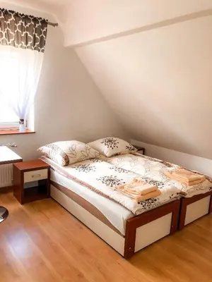 a small bedroom with a bed and a window at Dom u Kasi in Podwilk